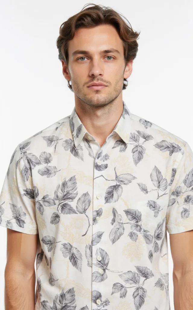 A French model wearing a Leaf pattern   printed shirt, against a white background, in a front   facing bust portrait